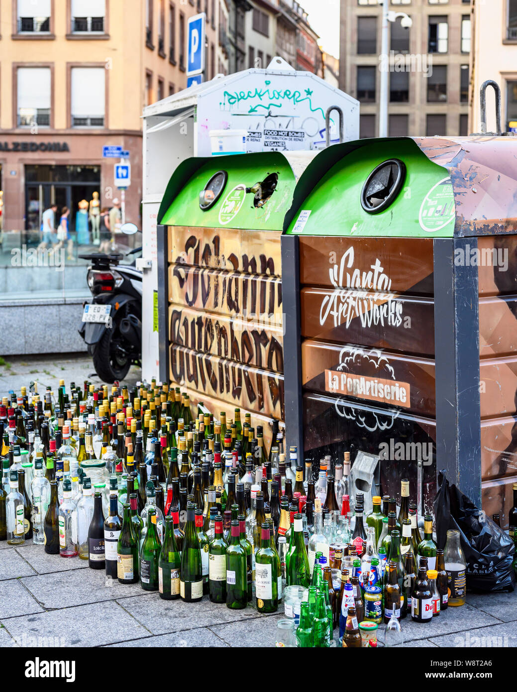 Empty glass bottles dumped in front of overflowing bottle banks, Strasbourg, Alsace, France, Europe, Stock Photo