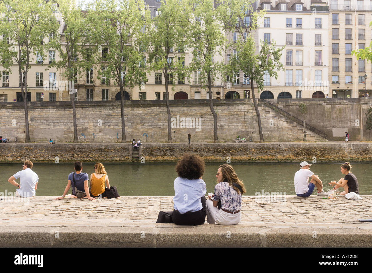 Paris river - People relaxing on the right embankment of the Seine River on a summer day in Paris, France, Europe. Stock Photo