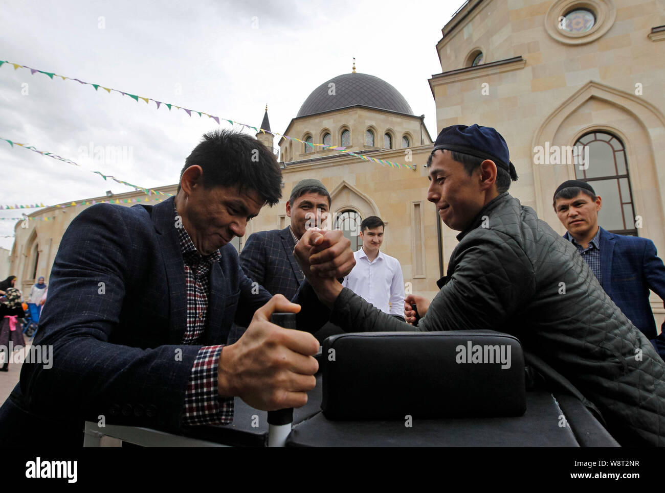 Muslim men have fun at the Ar-Rahma Mosque during the celebration.Eid al-Adha is the biggest celebration for Muslims in all over the world after Eid al-Fitr to commemorate the willingness of Ibrahim (also known as Abraham) to follow Allah's (God's) command to sacrifice his son. Stock Photo