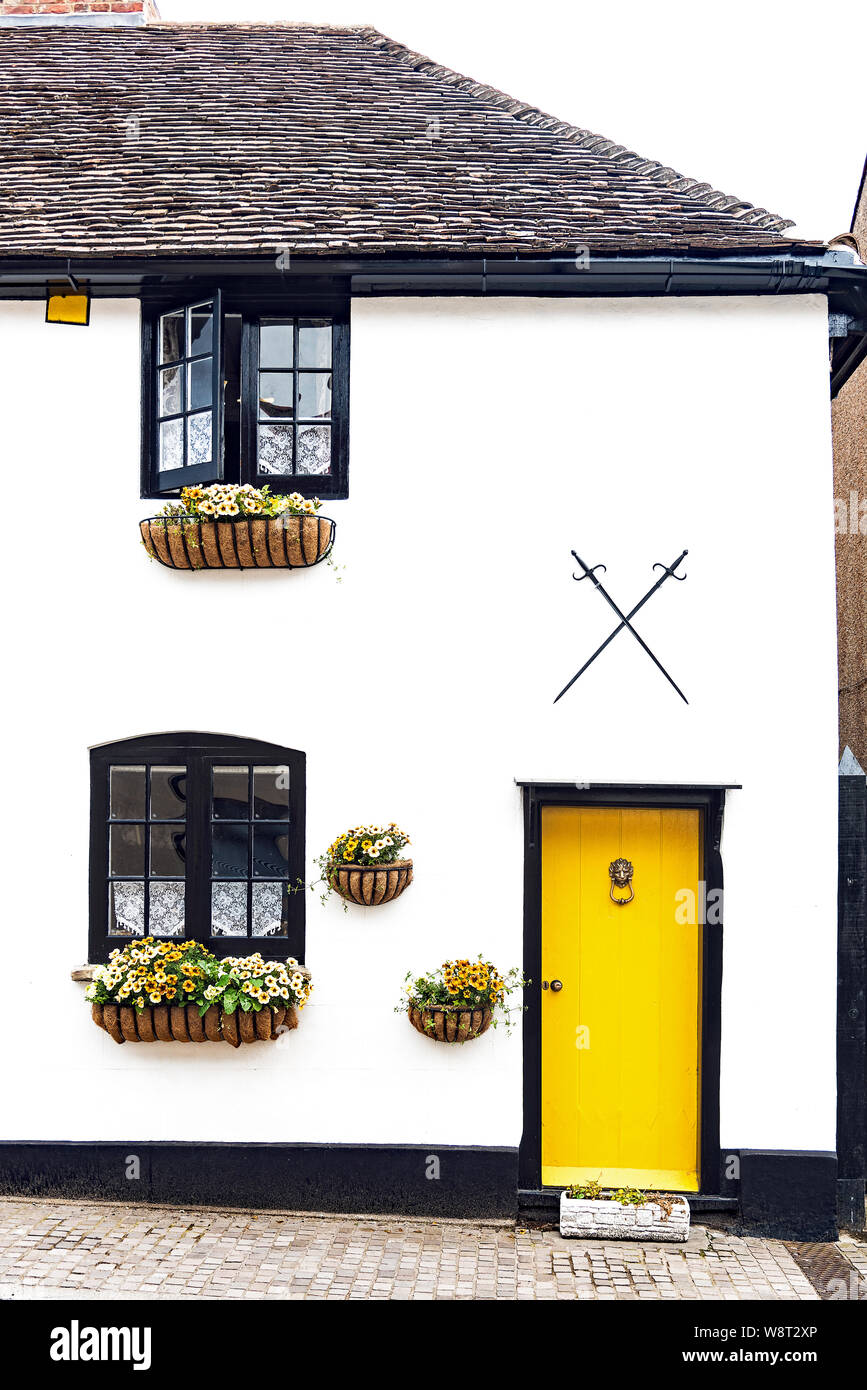 Yellow Door and white house - Cobham - U.K Stock Photo