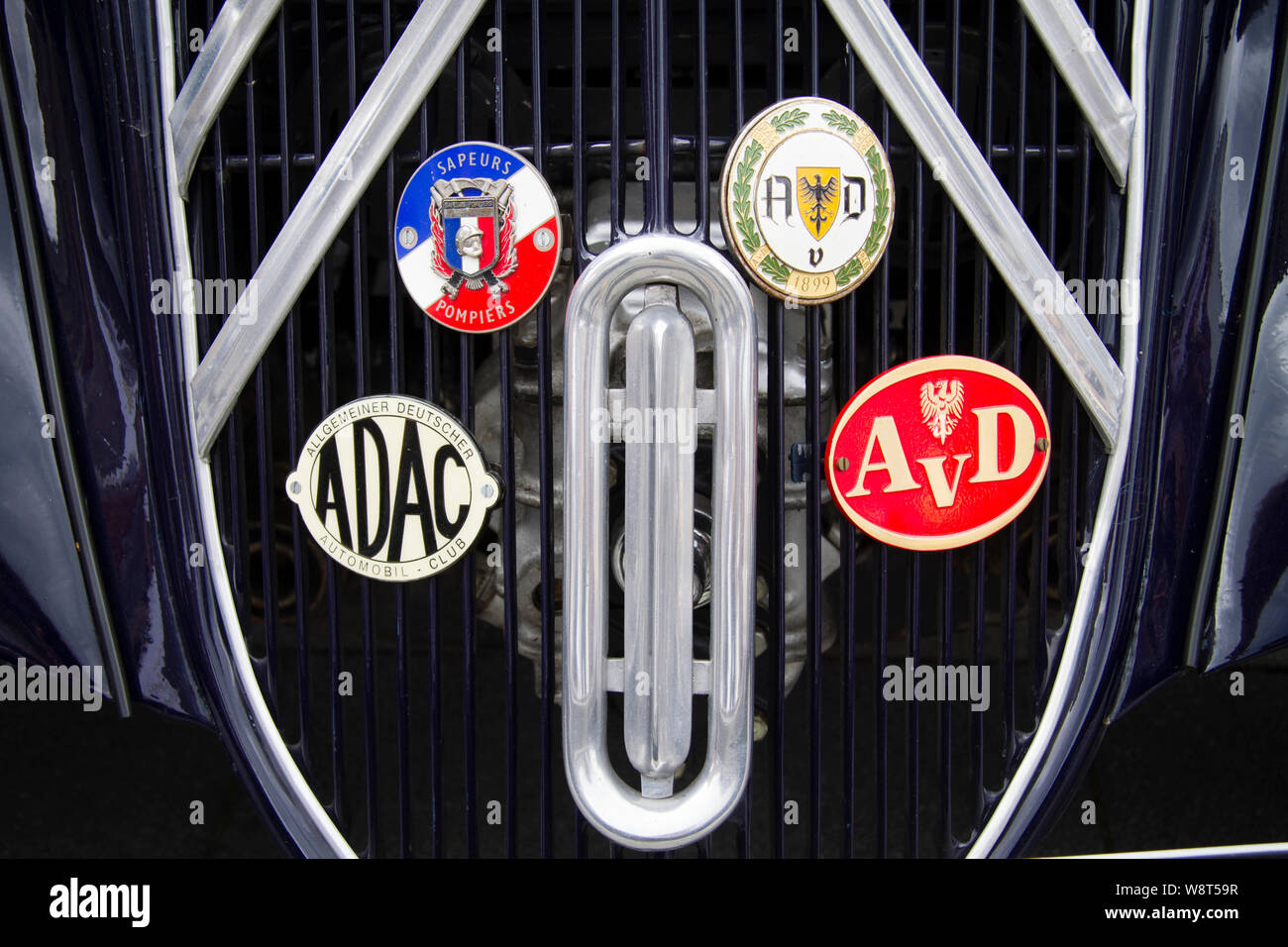 badges of automobile clubs on a radiator grill of a Citroen 15 CV Traction Avant, Germany.  Plaketten von Automobil-Clubs am Kuehlergrill eines Citroe Stock Photo