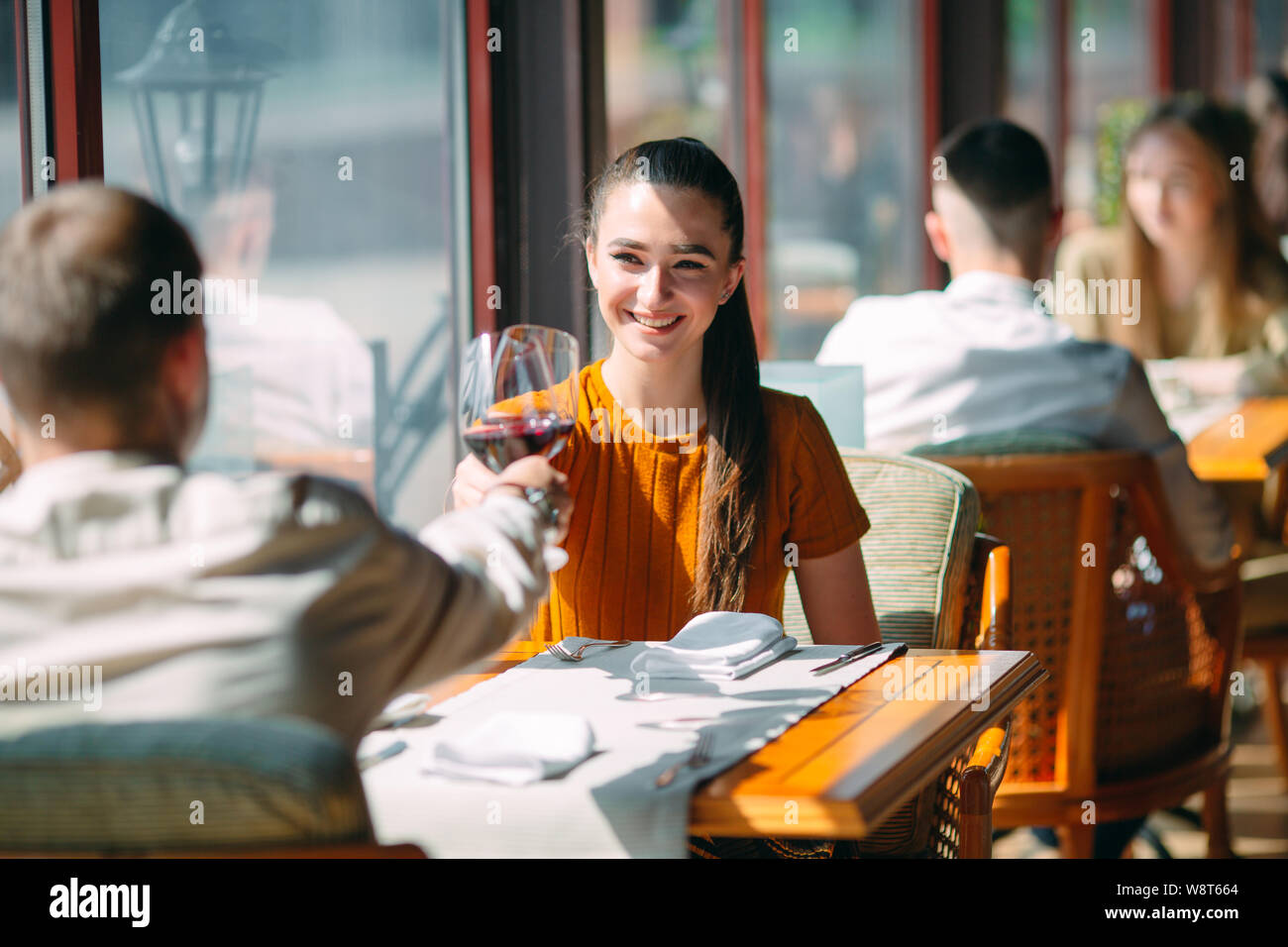 A young couple drinking wine in a restaurant near the window Stock ...