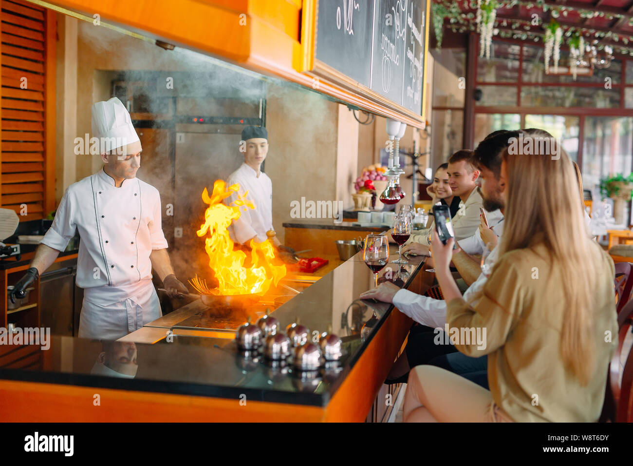 The chef prepares food in front of the visitors in the restaurant Stock ...