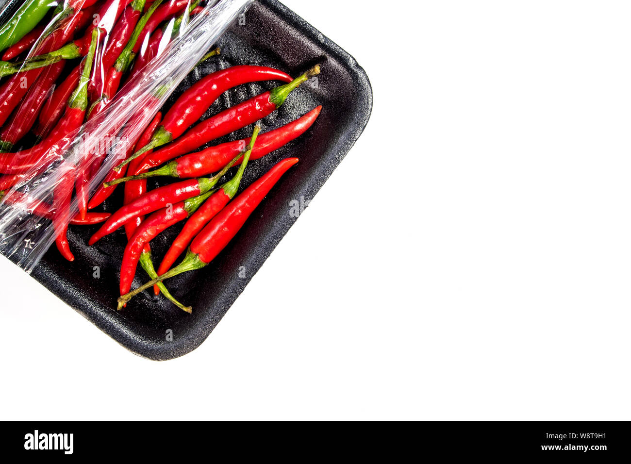 Red chili in foam and plastic package Stock Photo