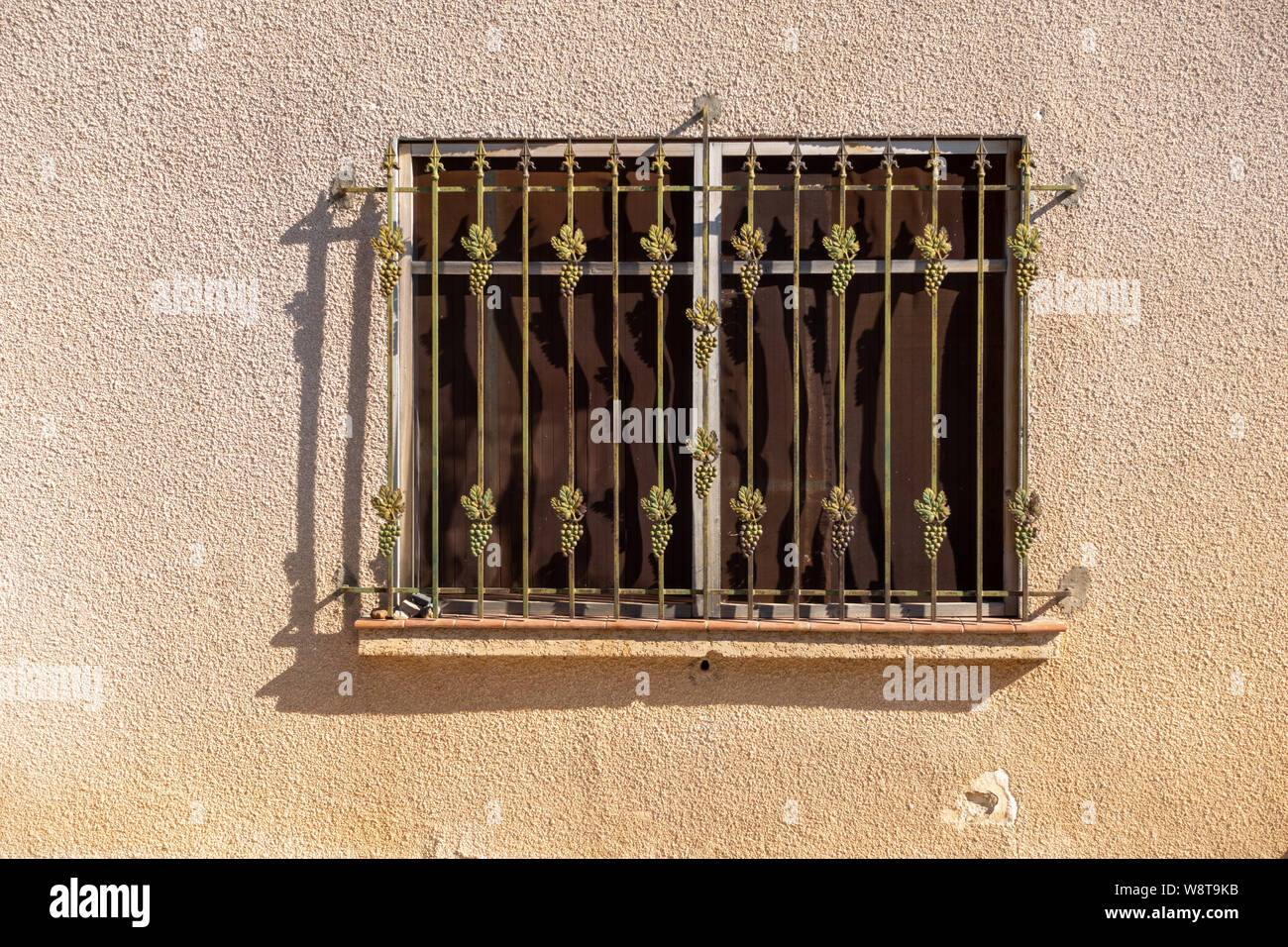 Metal grill on exterior house window Stock Photo
