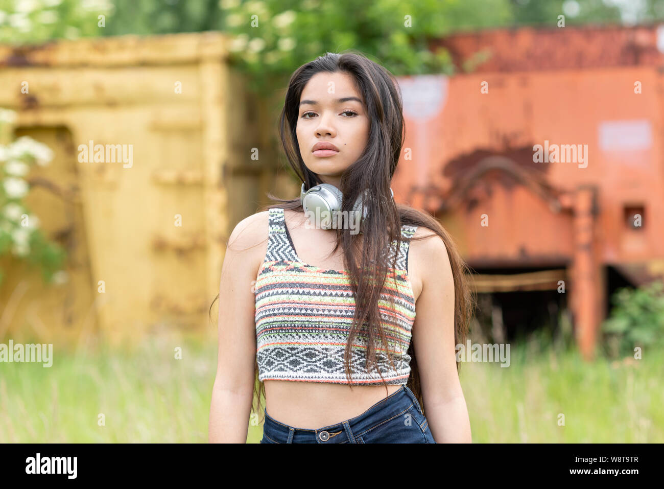 young beautiful asian woman wearing headphones outdoors Stock Photo