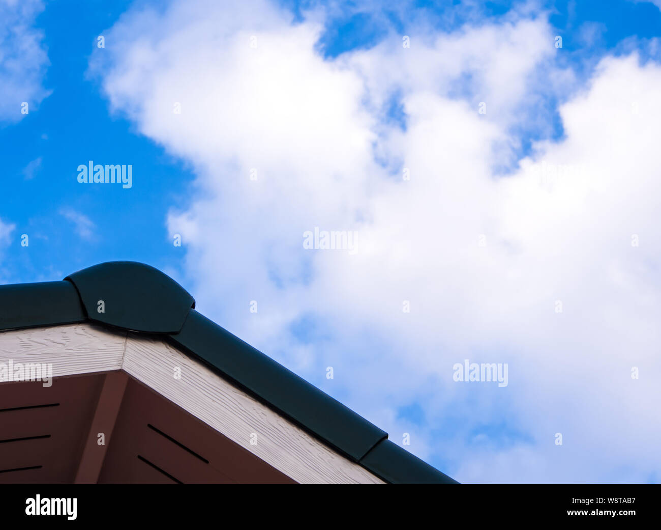 Gabled roof under a clouds and blue sky Stock Photo - Alamy