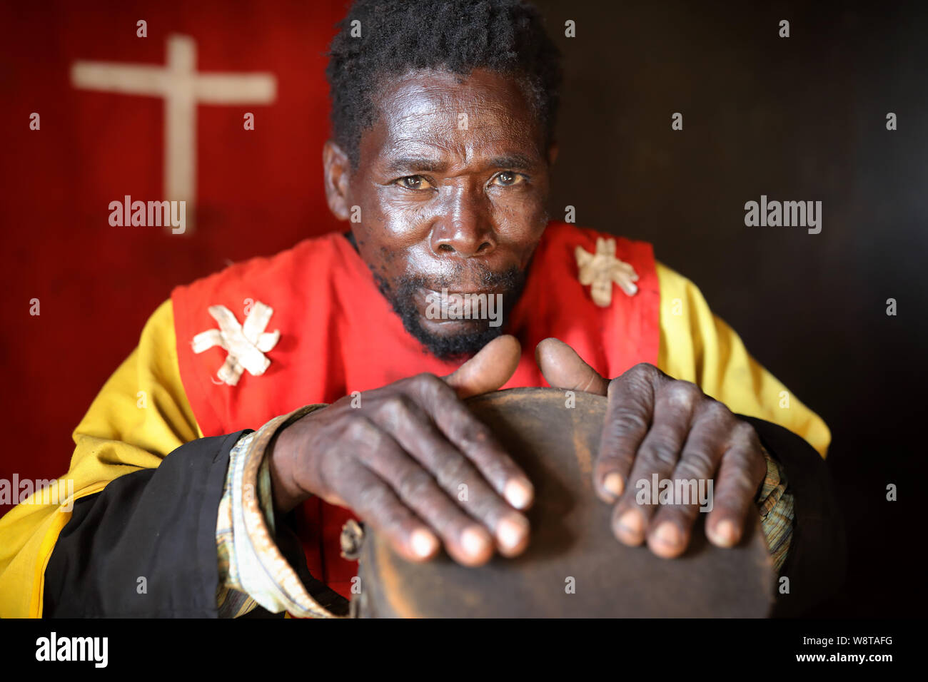 Traditional healer with a drum in a remote village near Dedza. Malawi is one of the poorest countries in the world. Stock Photo