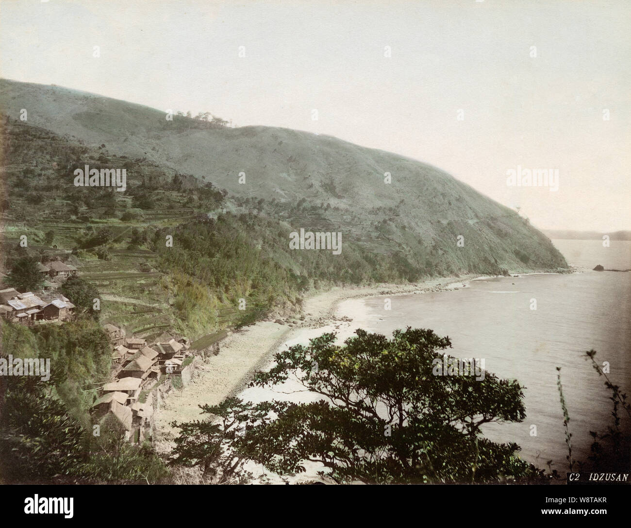 [ 1880s Japan - Japanese Coast at Atami, Shizuoka ] —   Panoramic view of the spa town of Atami in the Izu Peninsula, Shizuoka Prefecture. Shogun Tokugawa Ieyasu bathed in these springs as early as the 16th century and the spa resort was a popular destination for samurai and later the general public.  19th century vintage albumen photograph. Stock Photo