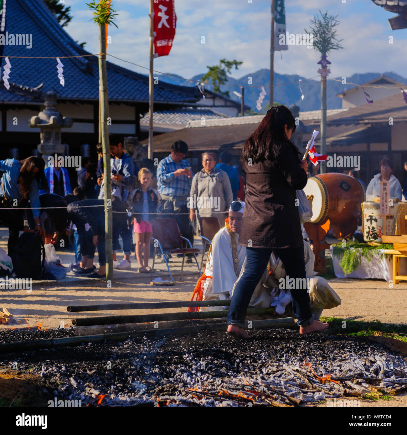 Buddhistic shintoistic ceremony of firewalk with people walking