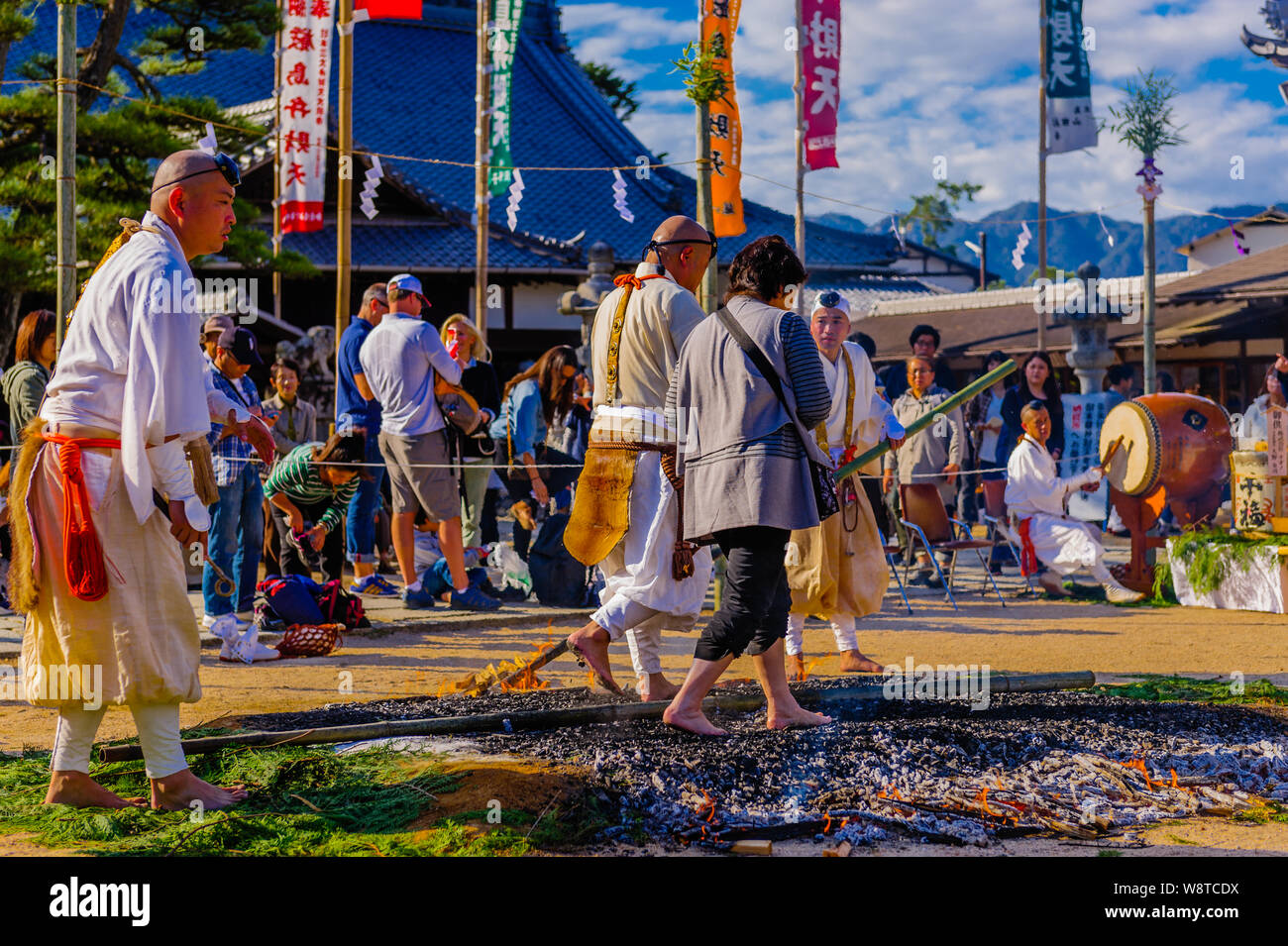 Buddhistic shintoistic ceremony of firewalk with people walking