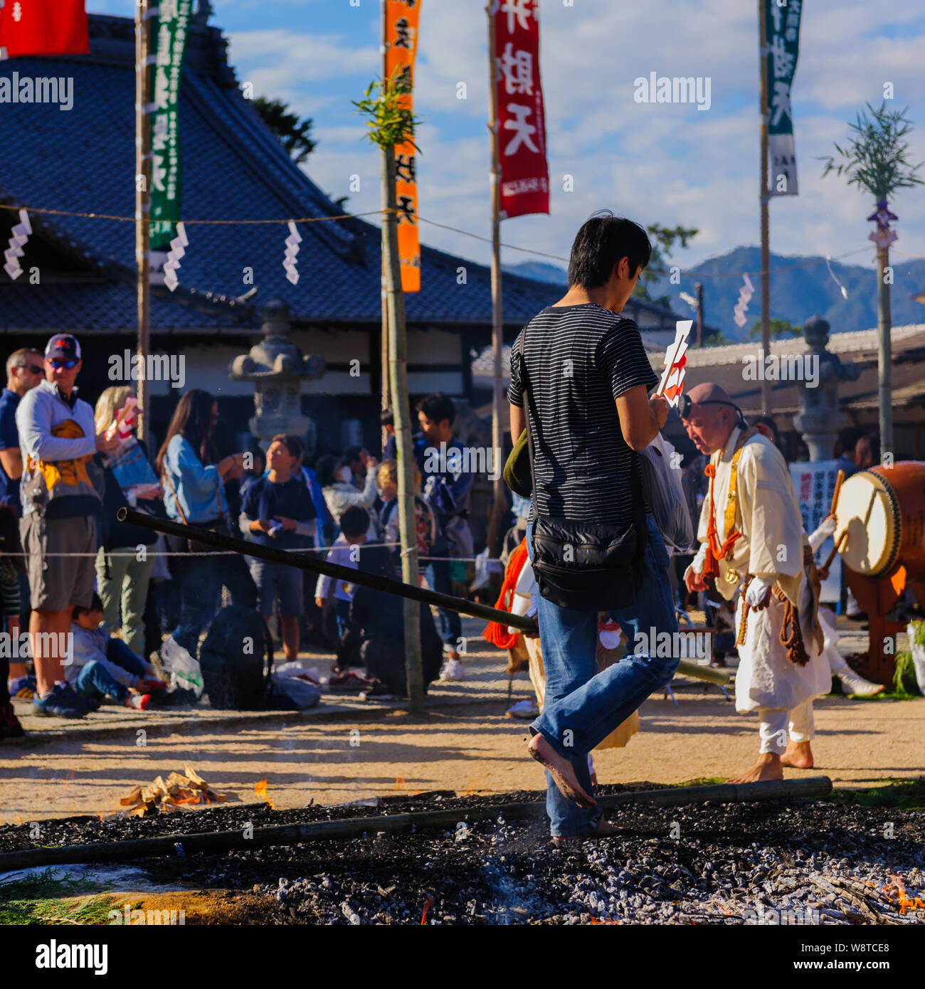 Buddhistic shintoistic ceremony of firewalk with people walking