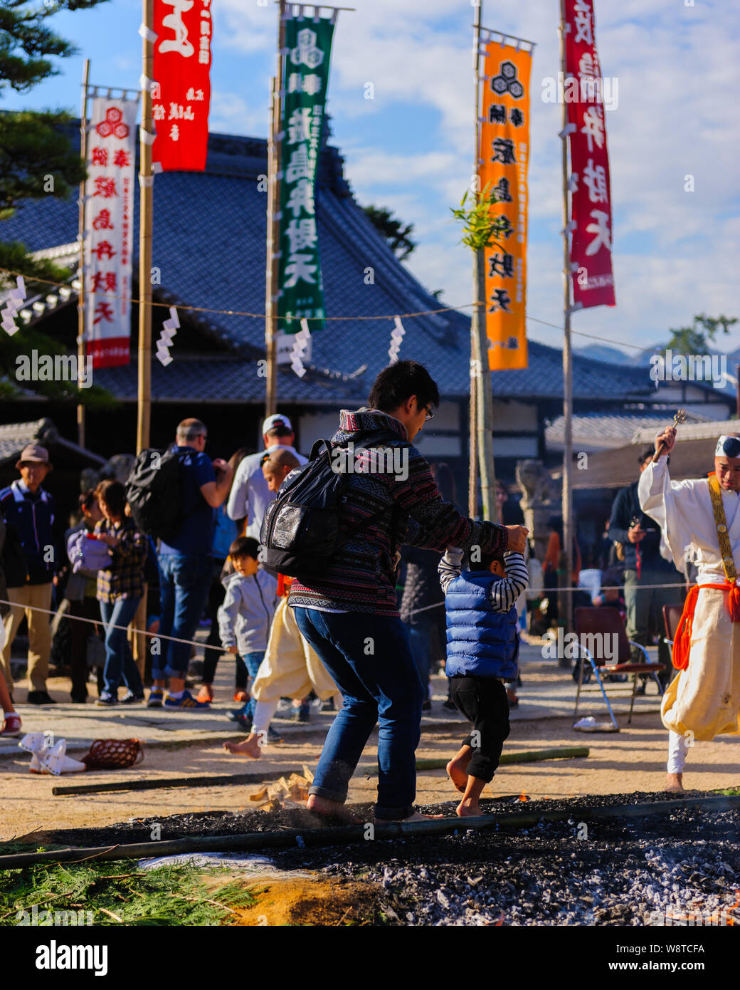 Buddhistic shintoistic ceremony of firewalk with people walking