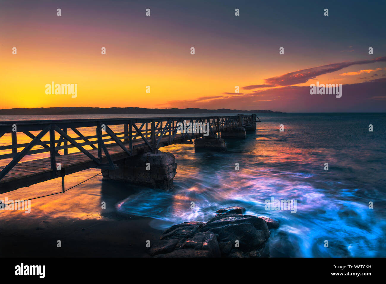 Pier in the harbour town of Luderitz at sunset in southwest Namibia Stock Photo