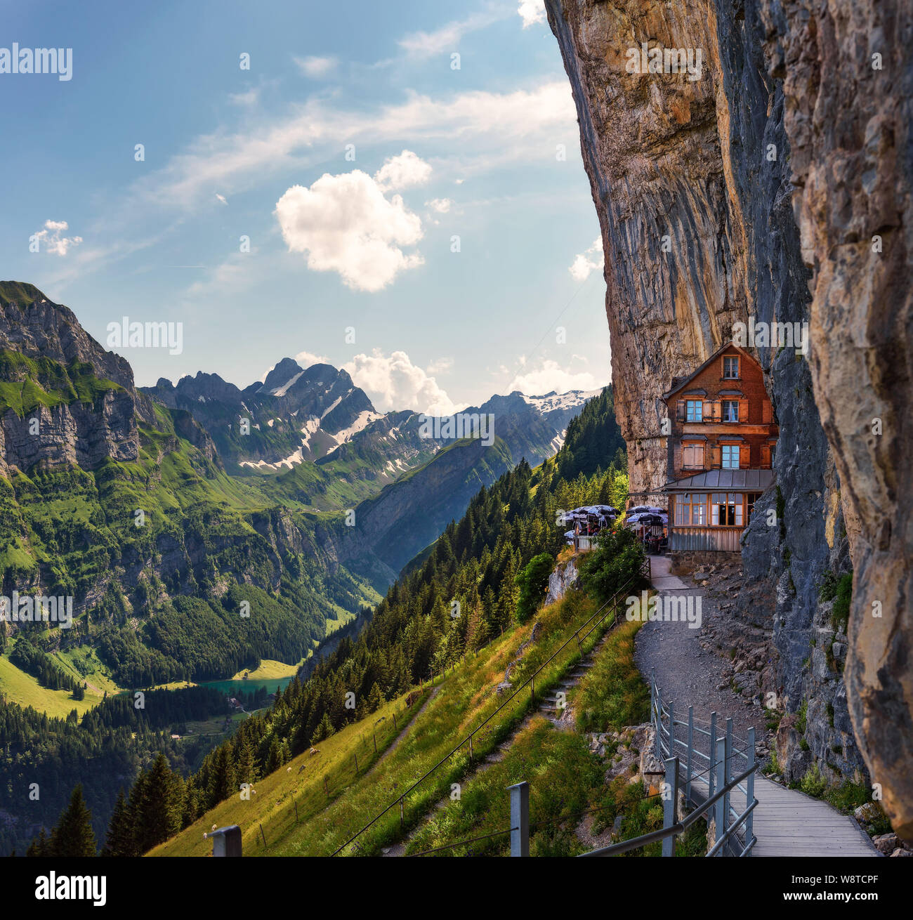 Swiss Alps and a restaurant under a cliff on mountain Ebenalp in Switzerland Stock Photo