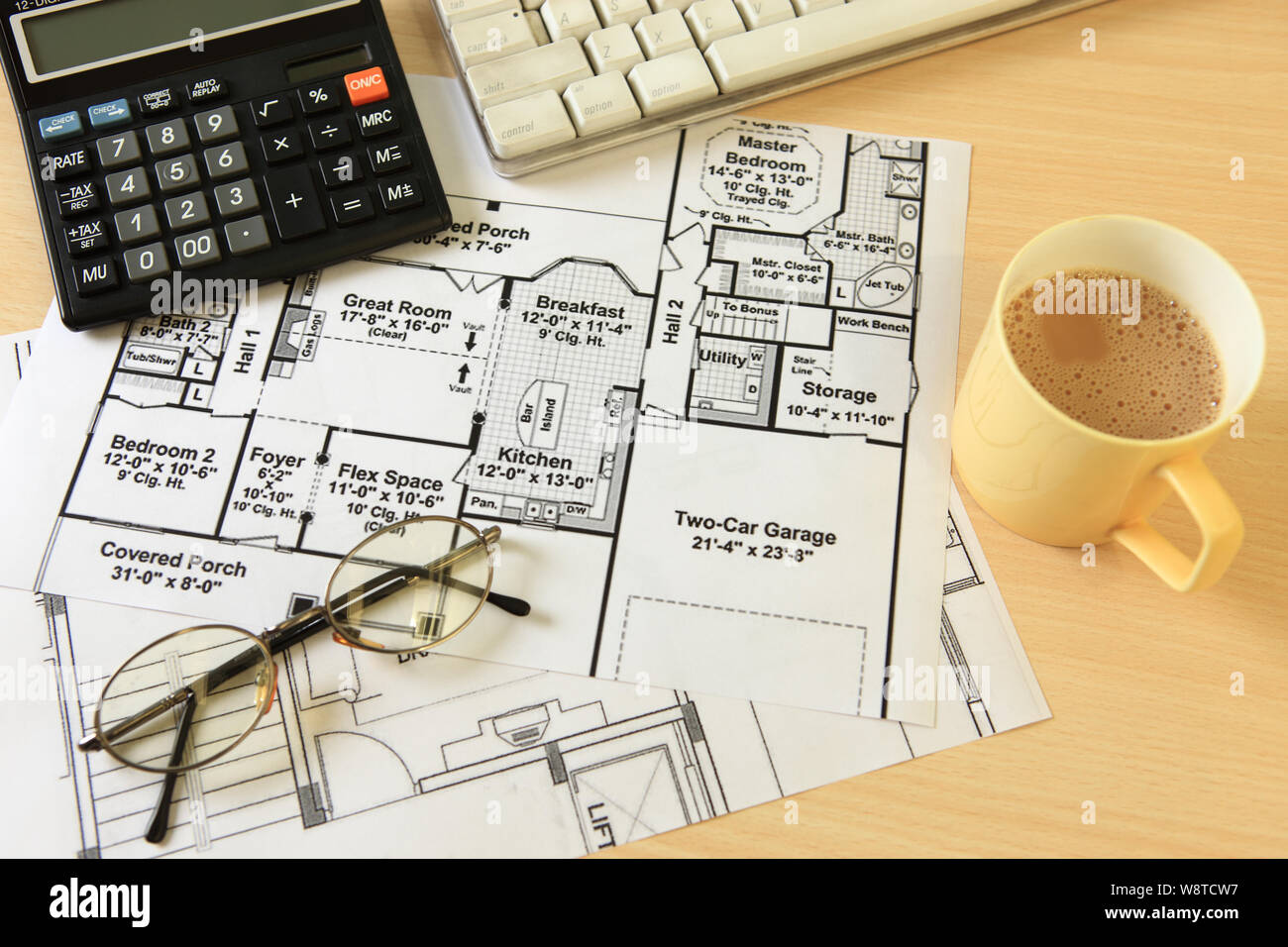 Blueprints of a house with coffee and a calculator Stock Photo - Alamy