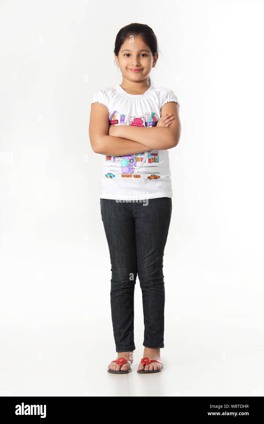 Girl standing with her arms crossed and smiling Stock Photo - Alamy