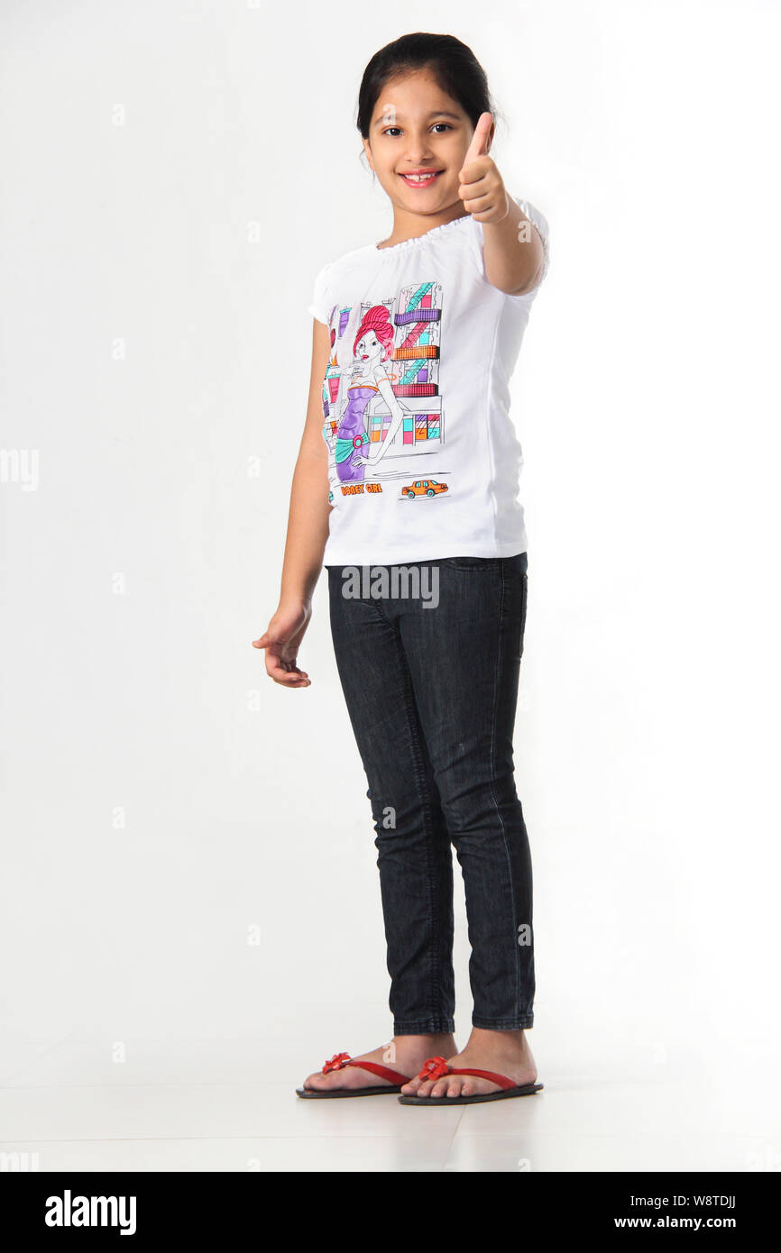 Girl showing thumbs up sign and smiling Stock Photo - Alamy