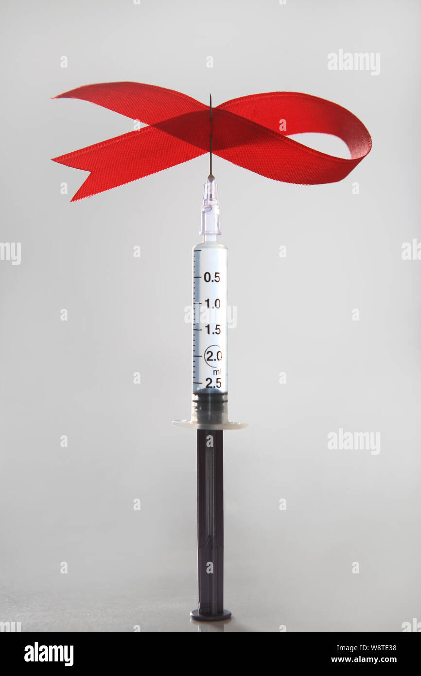 AIDS awareness ribbon with a syringe Stock Photo Alamy