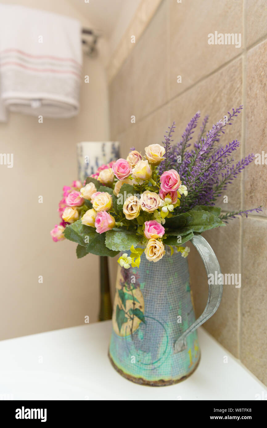 Artificial Flowers in Gold Vase at Room Corner Stock Photo - Alamy