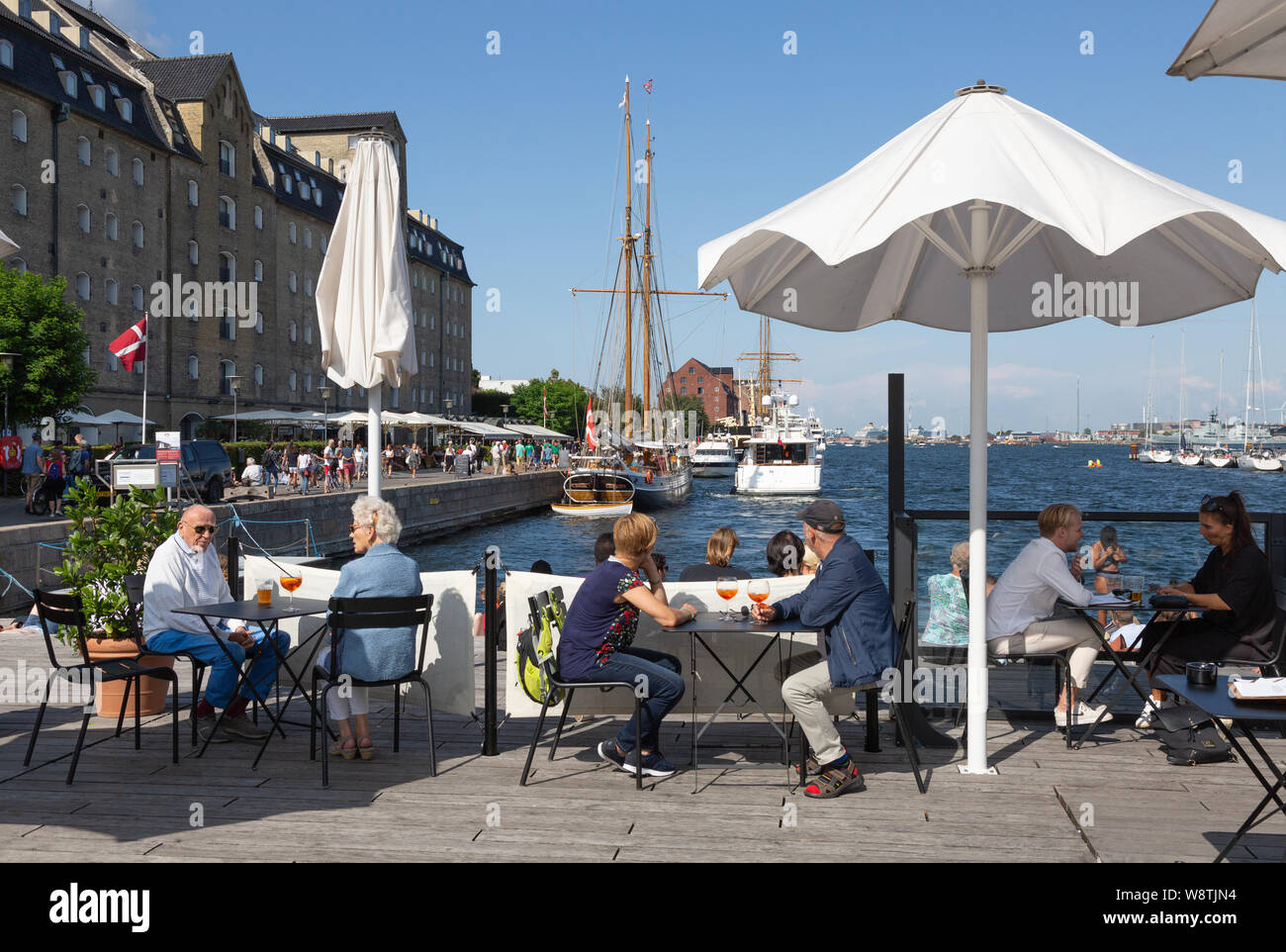 Copenhagen cafe; people drinking outside in summer sunshine, larsens Plads, Copenhagen, Denmark Scandinavia Europe Stock Photo