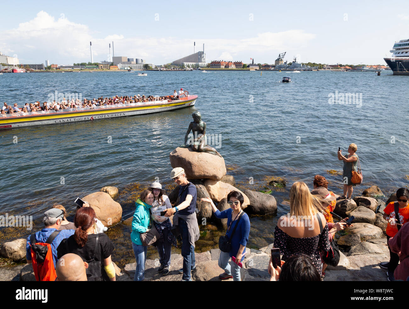 Copenhagen tourists - crowds of people looking at the famous statue of the Little Mermaid, Copenhagen Denmark Scandinavia Europe Stock Photo