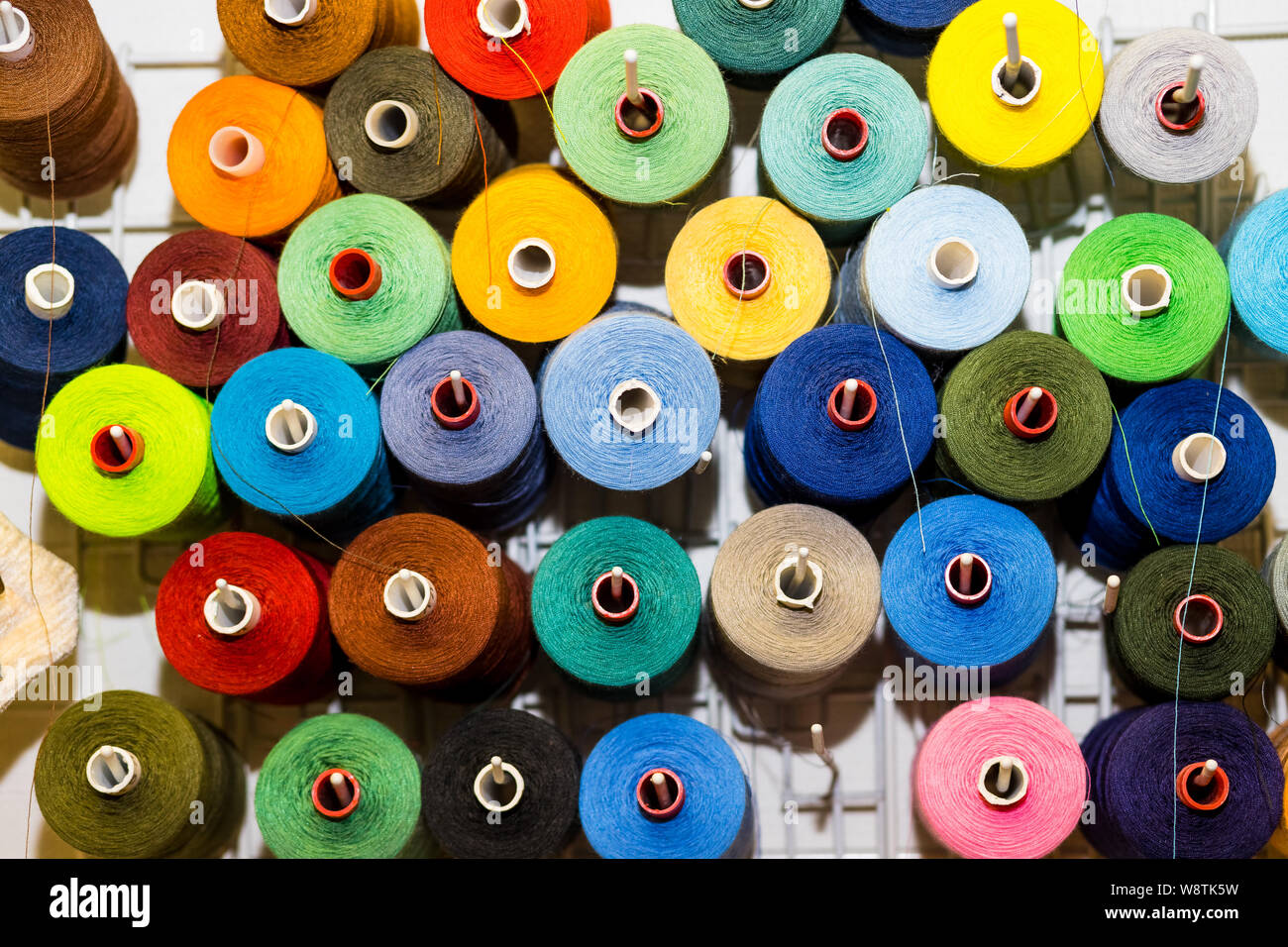 Top view variety big and used spools of colorful sewing threads. Tailor ...