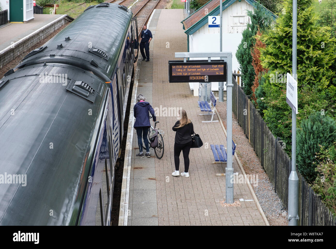 Passenger with bicycle for ScotRail train at Strathcarron Station, Wester Ross, NW Highlands of Scotland. Stock Photo