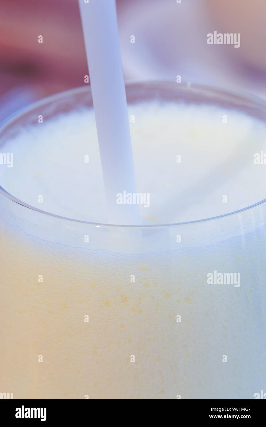 Close up delicious homemade milkshake with straw texture background. Stock Photo