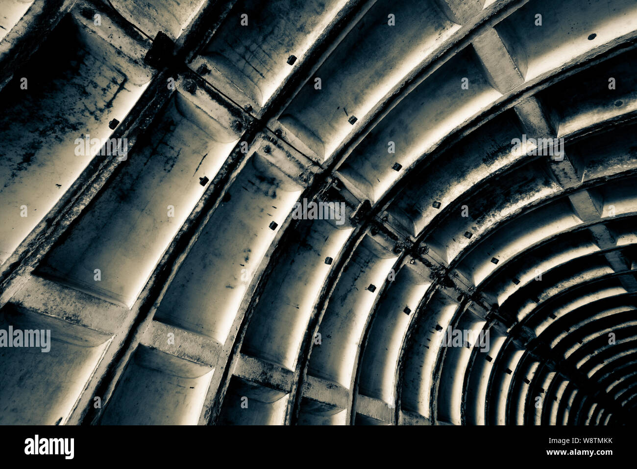 Abstraction for the background. Stiffeners in a concrete military structure. Hard light. Black and white.Tinted. Stock Photo