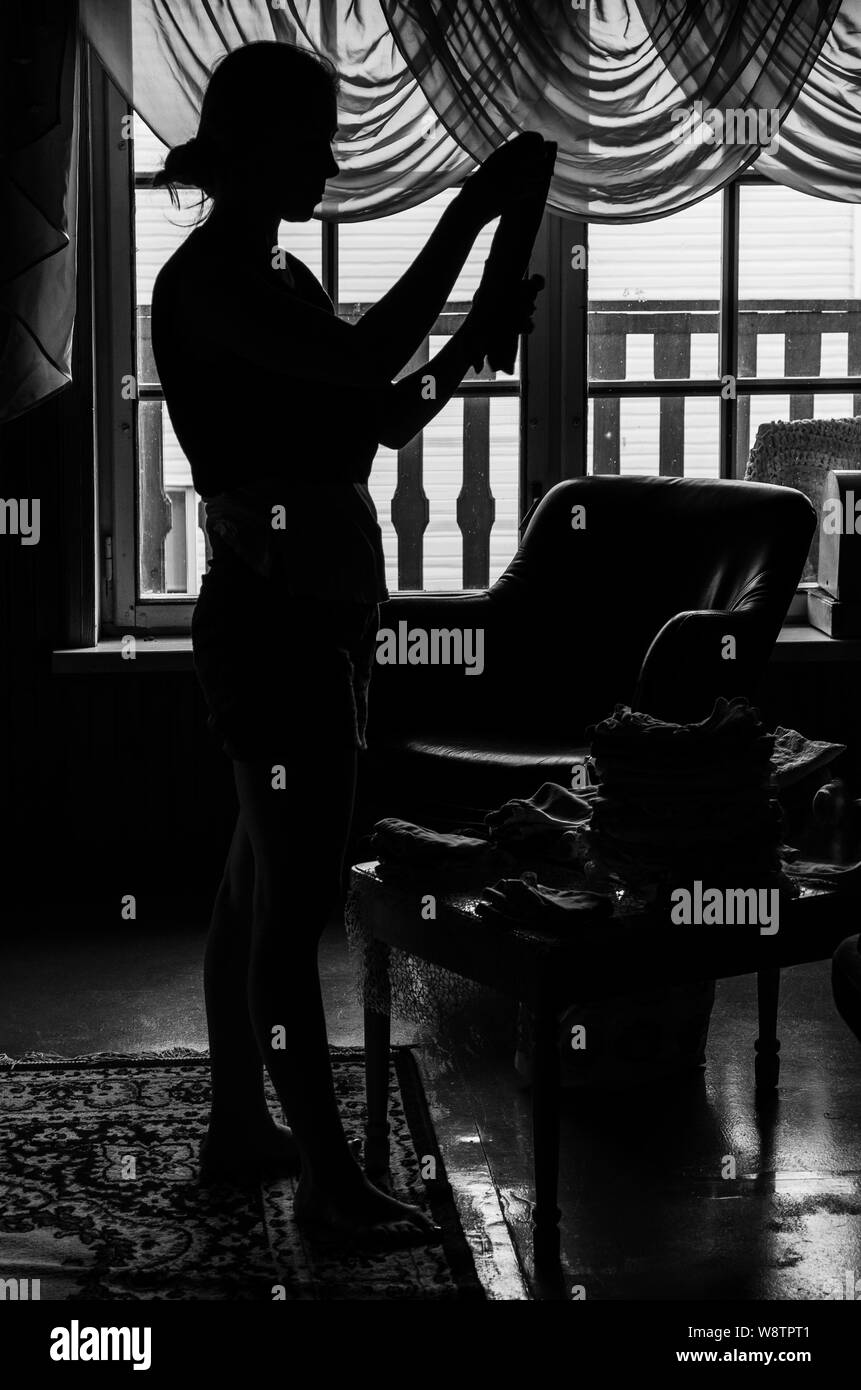 Silhouette of a woman indoors in black and white Stock Photo
