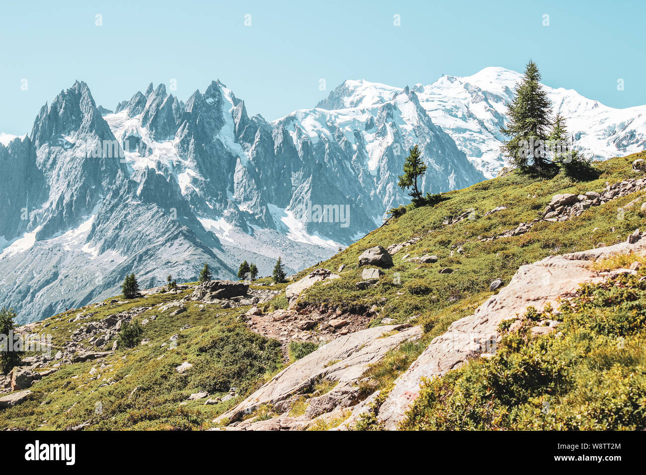 Alpine landscape with snow capped mountains including the highest mountain of Europe Mount Blanc. Photographed in late summer near Chamonix, France. French Alps in summer. Adventure, mountain hiking. Stock Photo