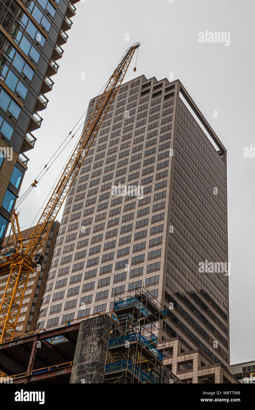 New Glass Tower Construction with Yellow Crane in Seattle Stock Photo