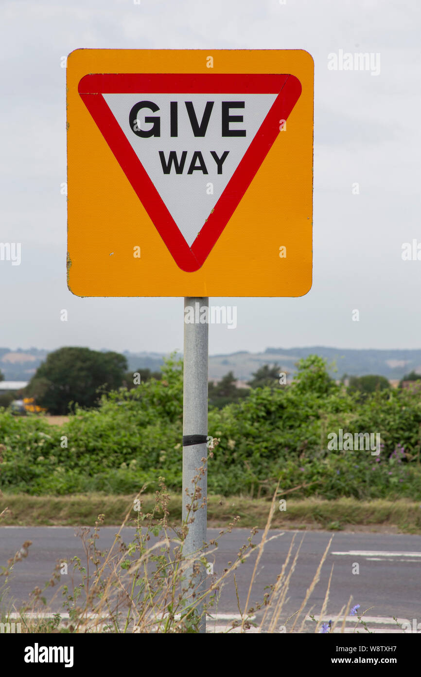 Give Way sign at road junction Stock Photo Alamy