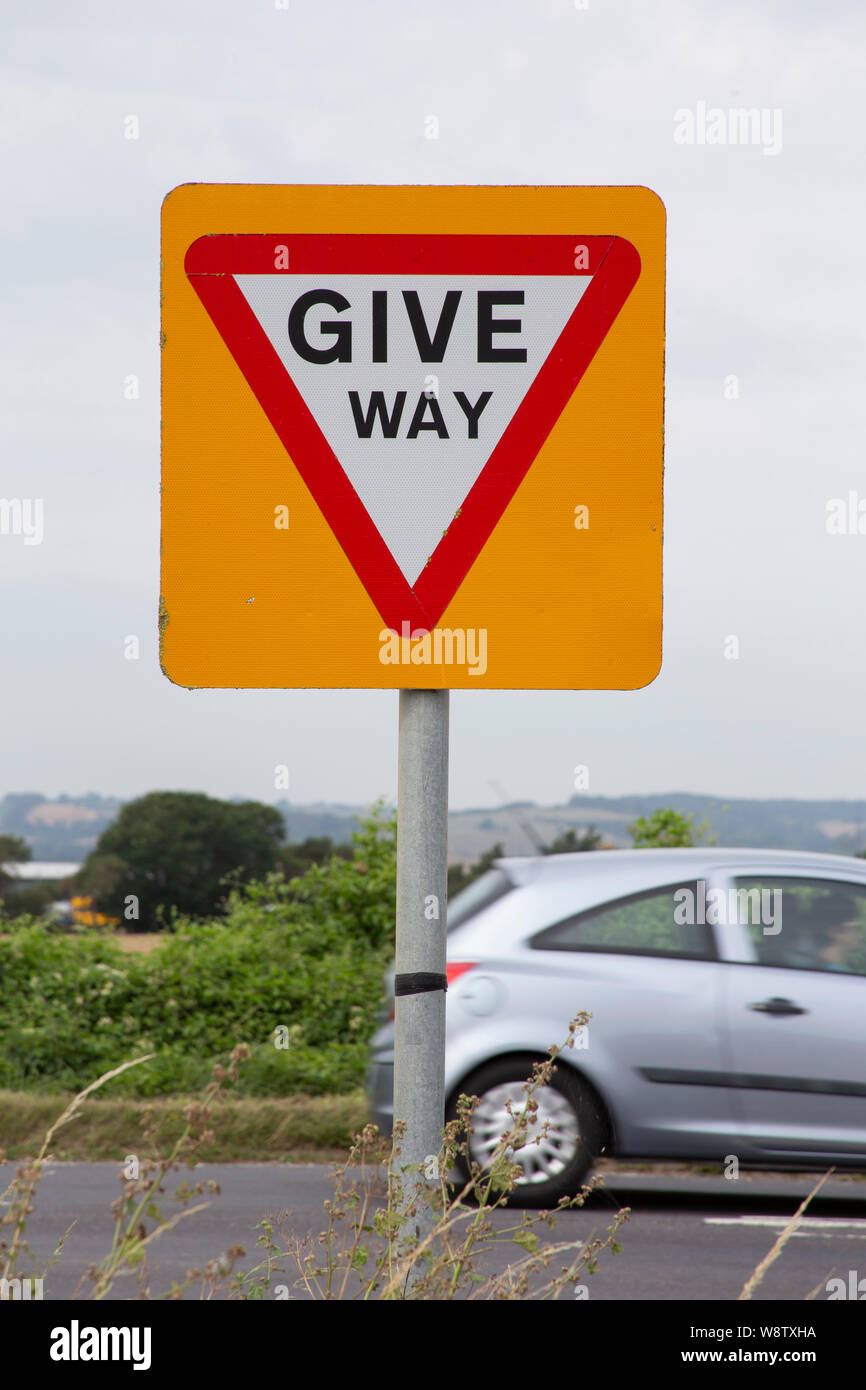 Give Way sign at road junction Stock Photo - Alamy