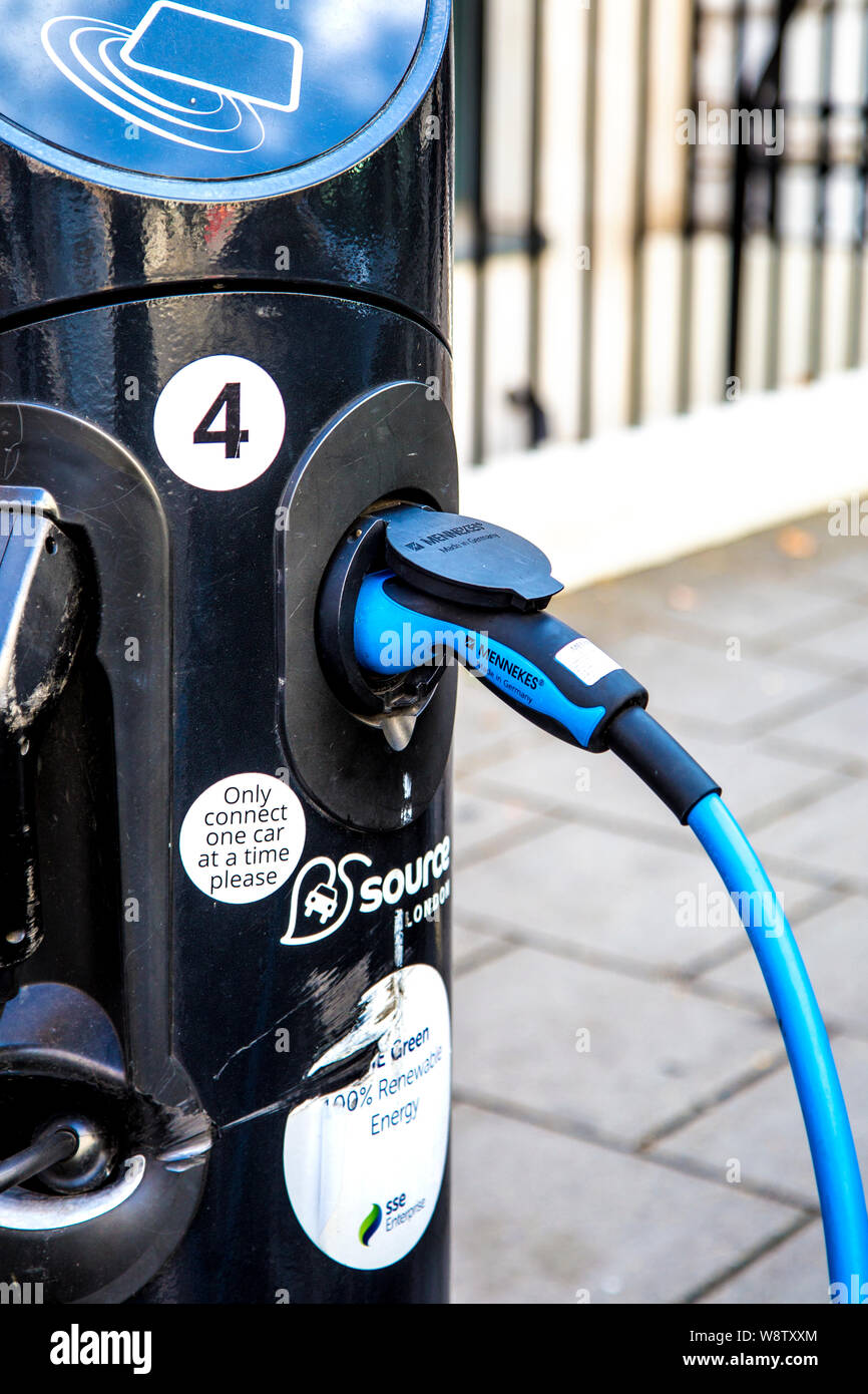 Electric car plugged into a charger, Source charging station (London, UK) Stock Photo