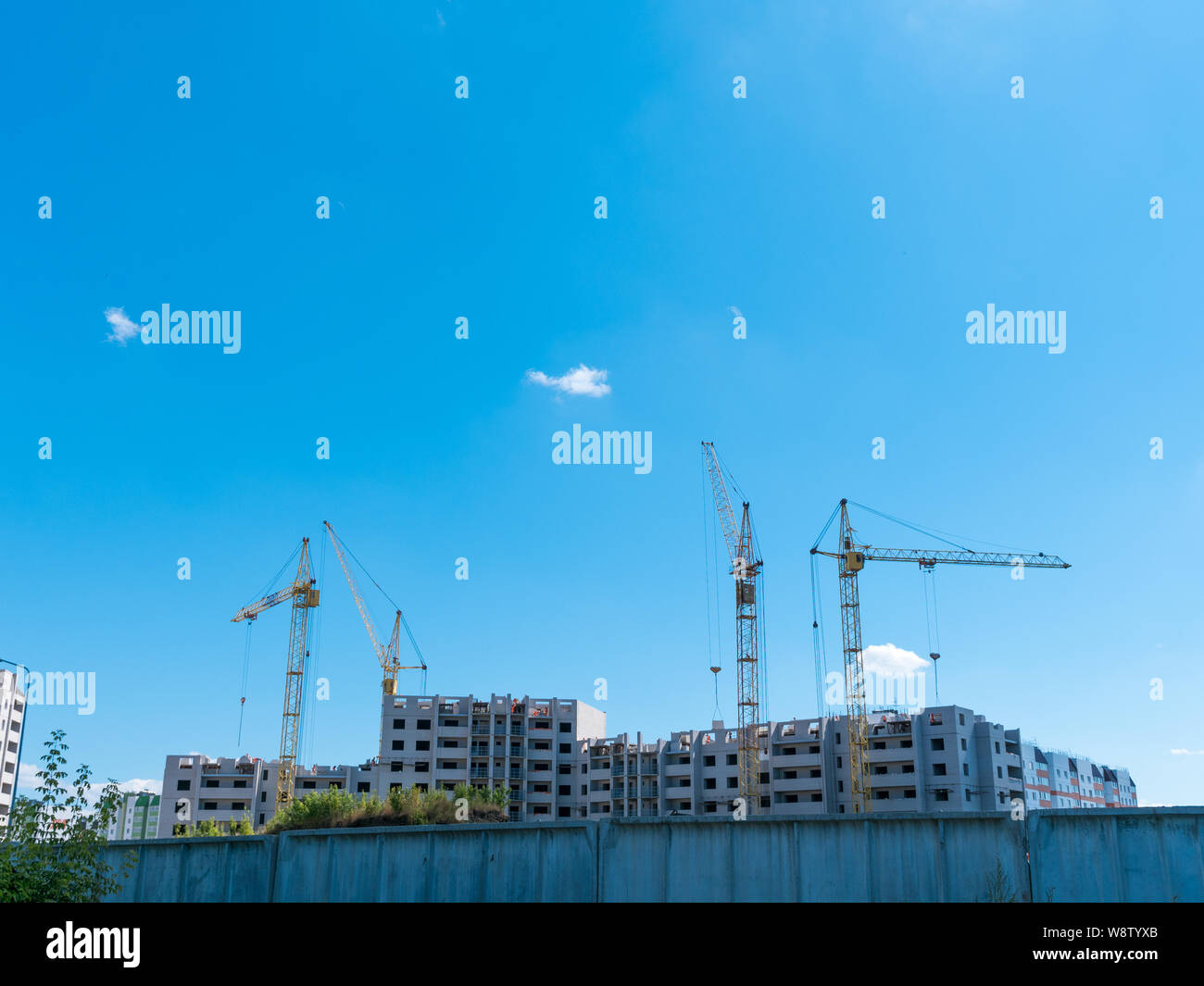 Construction site with many cranes against the sky Stock Photo - Alamy