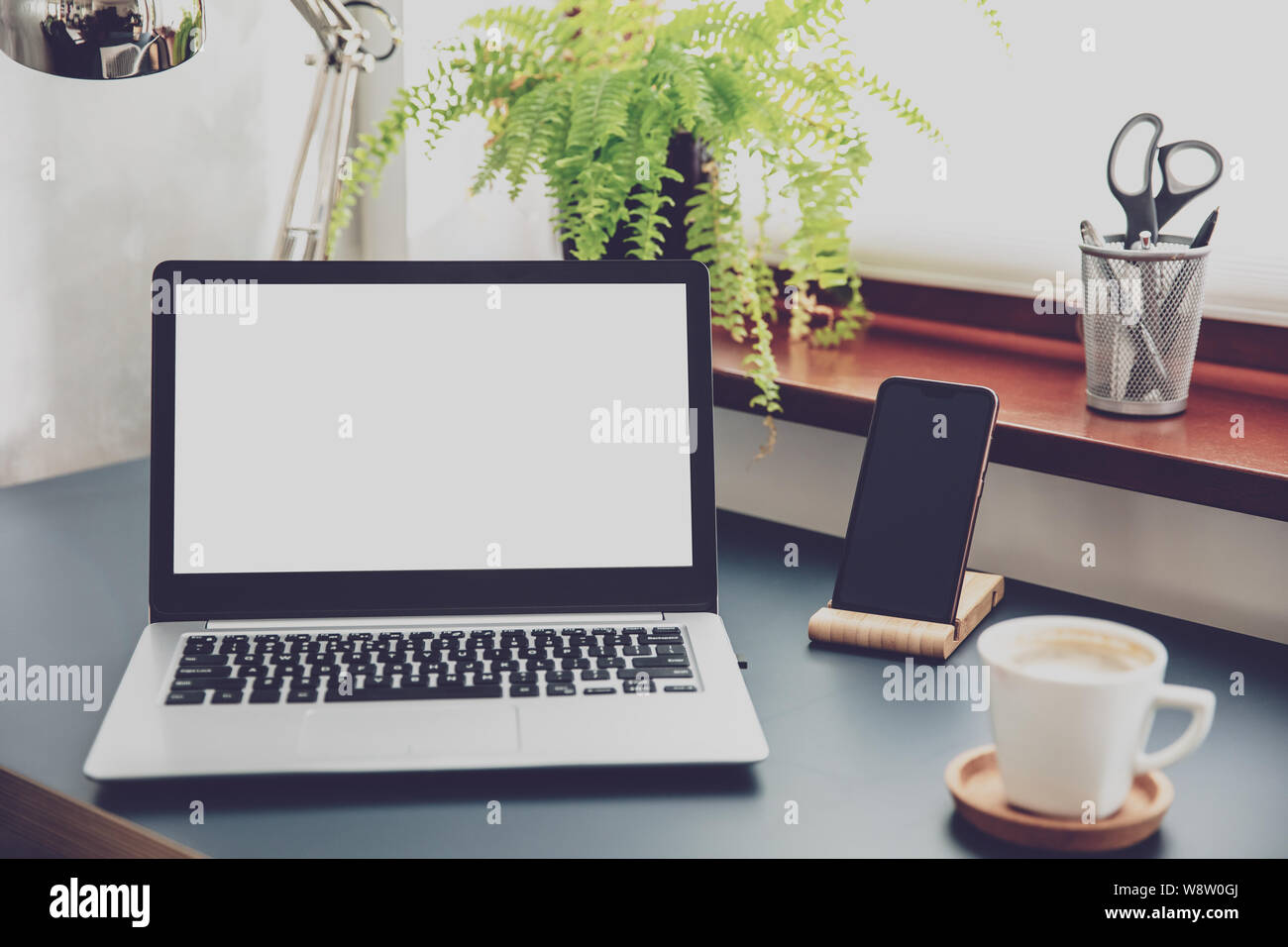 Composition of office devices and white laptop screen. Stock Photo