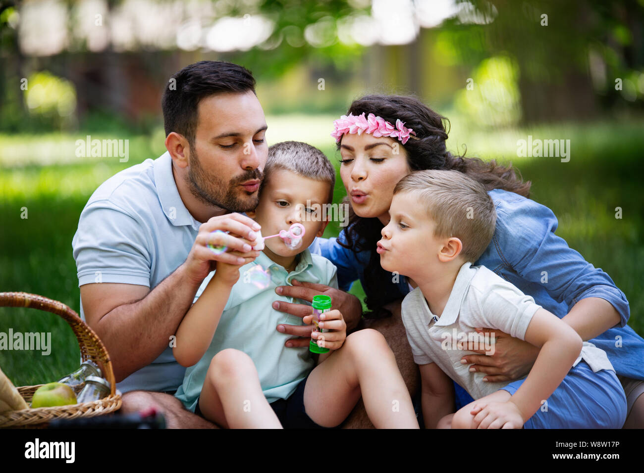 Family with children blow soap bubbles outdoors Stock Photo - Alamy