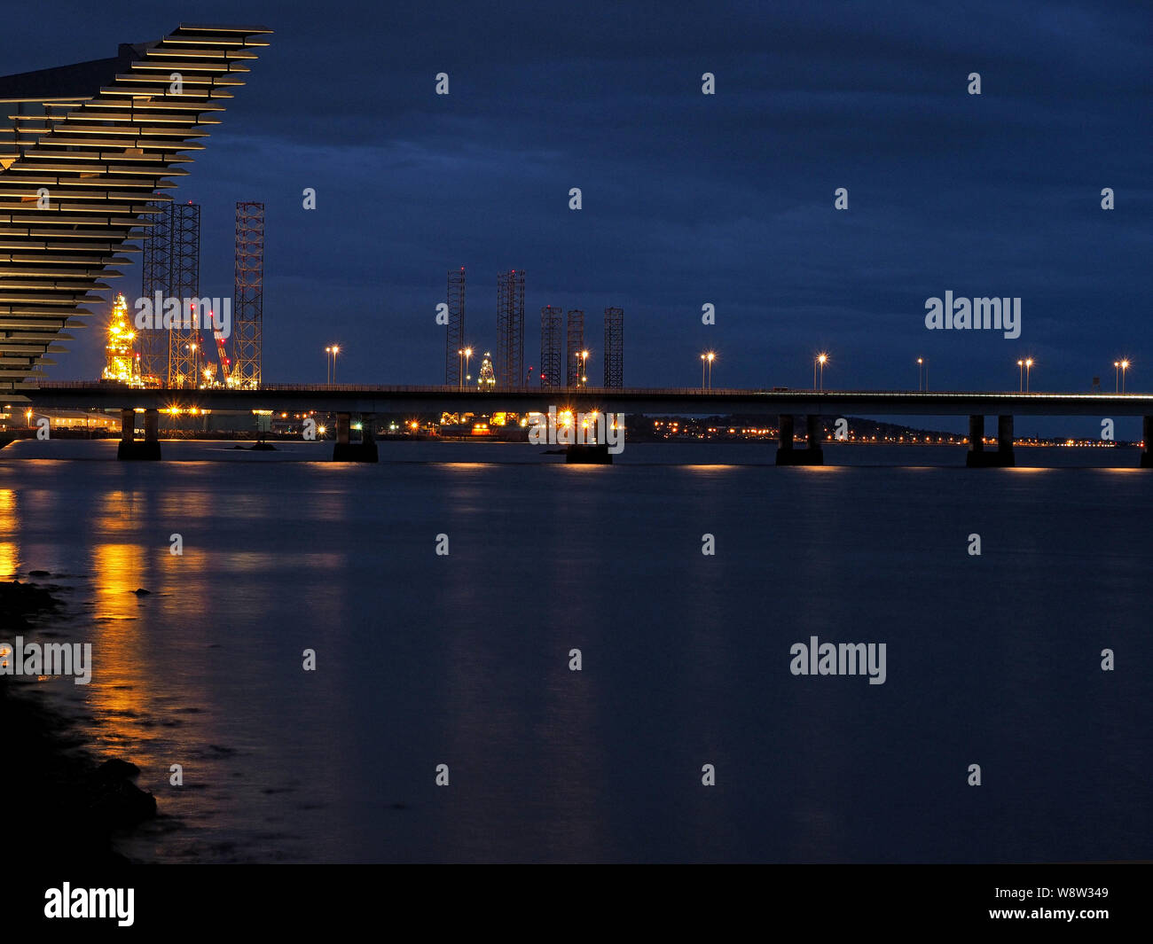 night time illuminated view of the Tay Road Bridge with the dramatic angles of the new V & A museum in the foreground Dundee, Scotland, UK Stock Photo