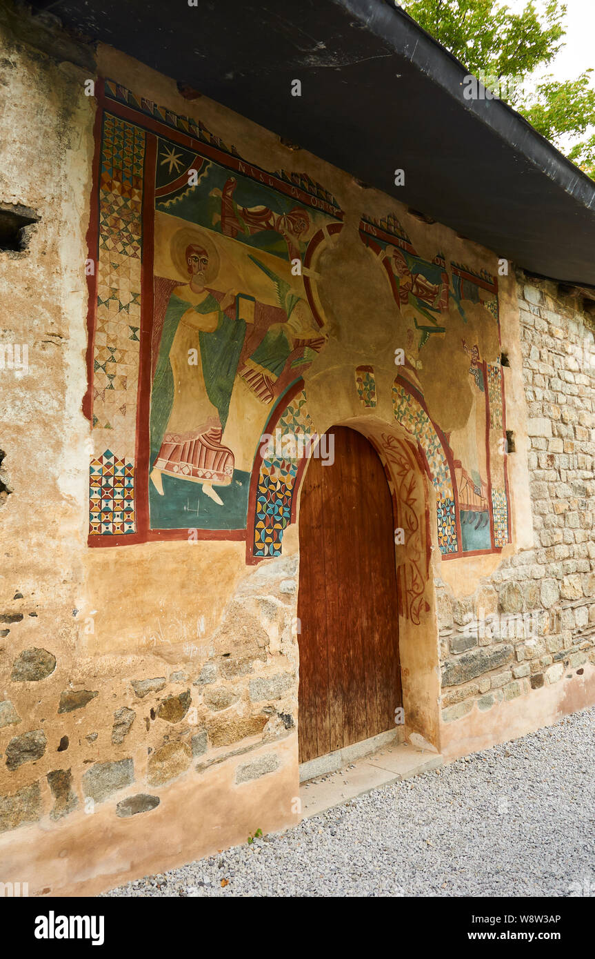 Sant Joan de Boí church entrance with romanesque paintings showing a theophany (Bohí valley, Alta Ribagorza, Lleida, Pyrenees, Cataluña, Spain) Stock Photo