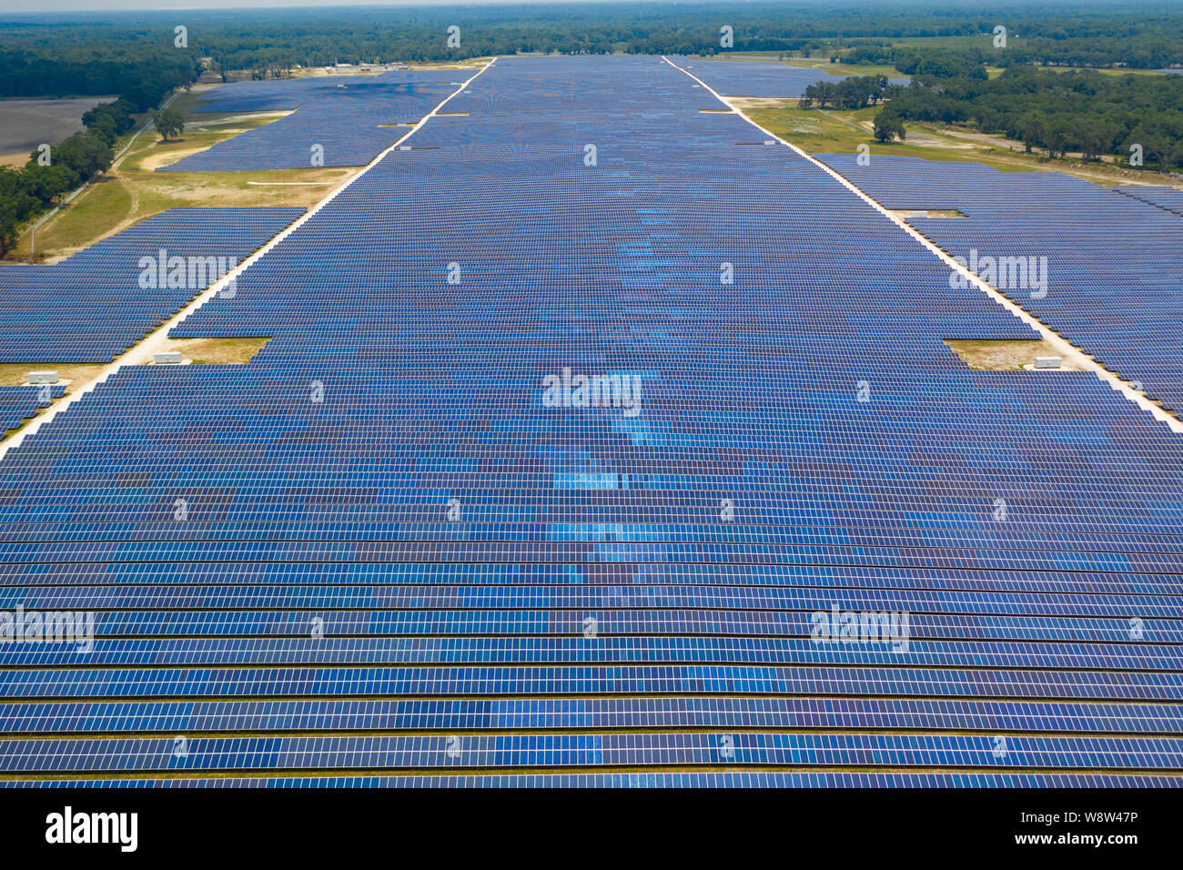 Aerial view of large solar panel farm in Northern Florida providing