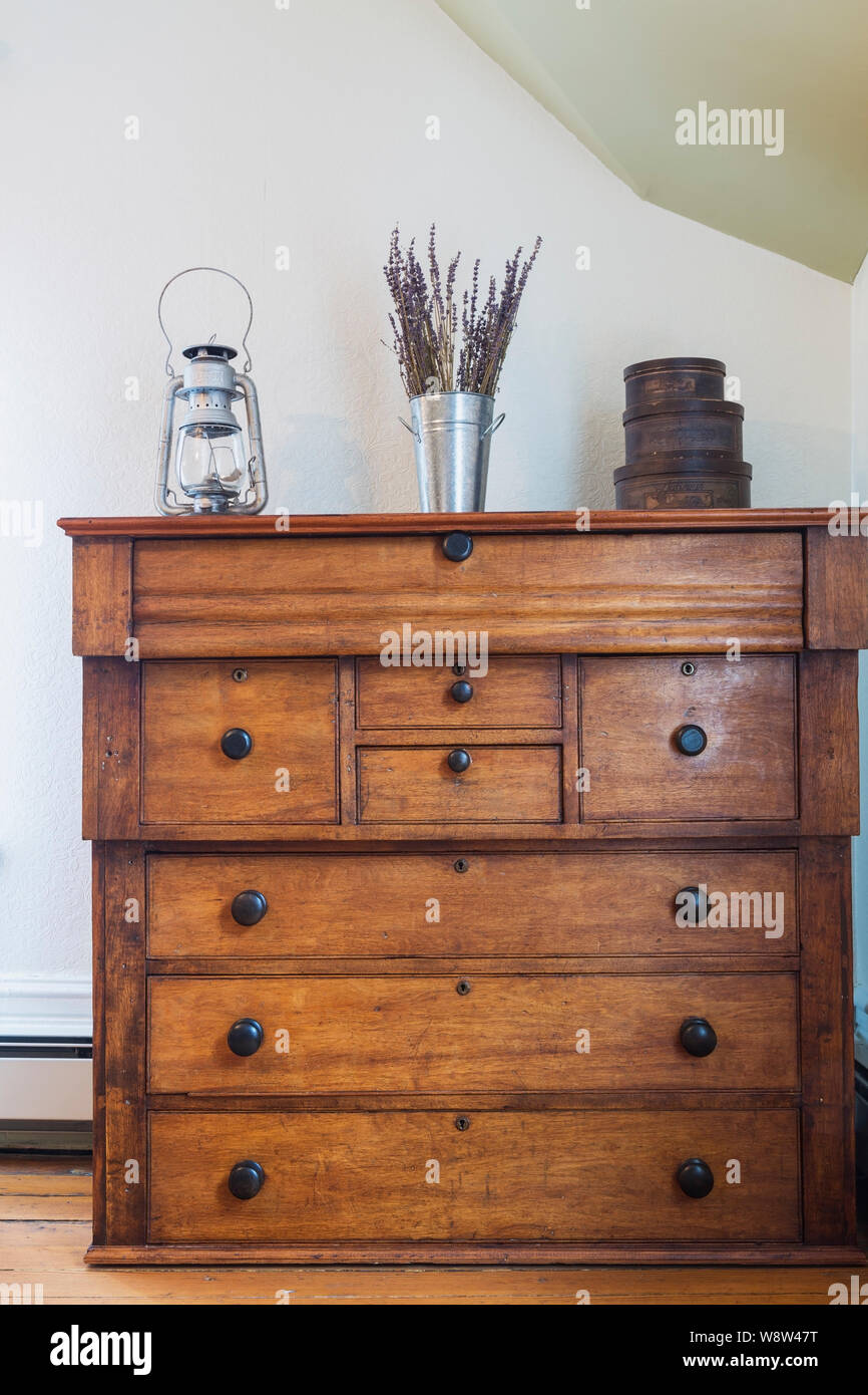 Antique Pine Wood Chest Of Drawers Decorated With Old Oil Lamp