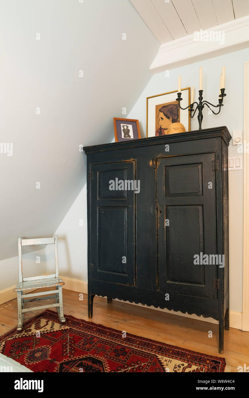 Antique Wooden Armoire And Child S Rocking Chair On Rug In