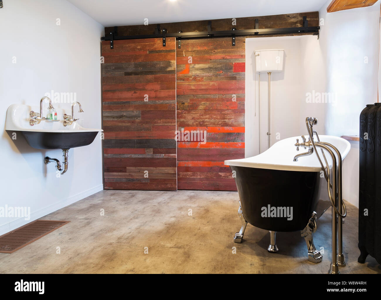 White And Black Freestanding Chrome Claw Foot Bathtub Next To Hot