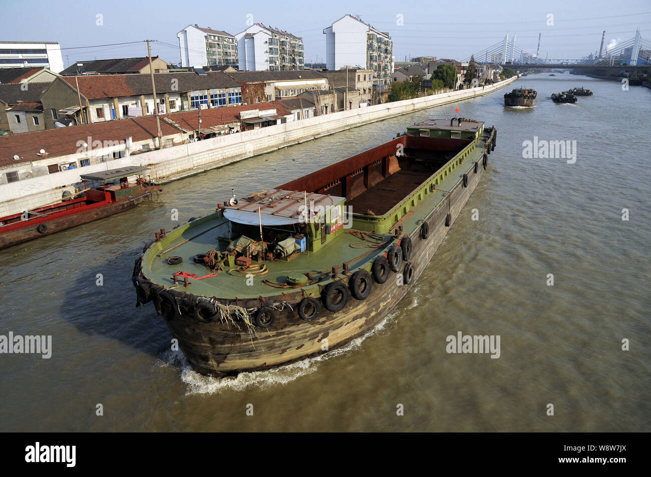 --FILE--Boats sail along the Grand Canal in Changzhou city, east Chinas Jiangsu province, 18 November 2013.   Chinas Grand Canal, the longest artifici Stock Photo
