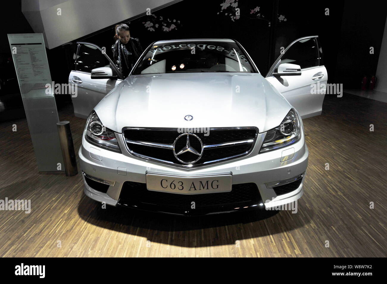 File A Trendy Young Woman Tries Out A Mercedes Benz C63 Amg During An Auto Show In Beijing China 30 October 13 Mercedes Benz May Be One Of T Stock Photo Alamy