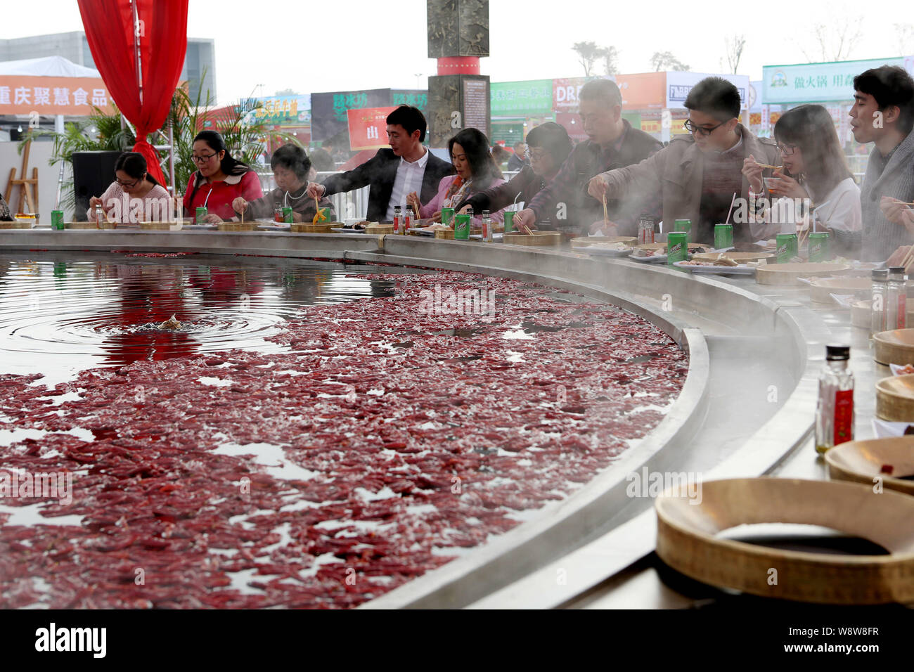 Chinese customers dine around a giant hotpot during the 7th National Hot Pot Festival in