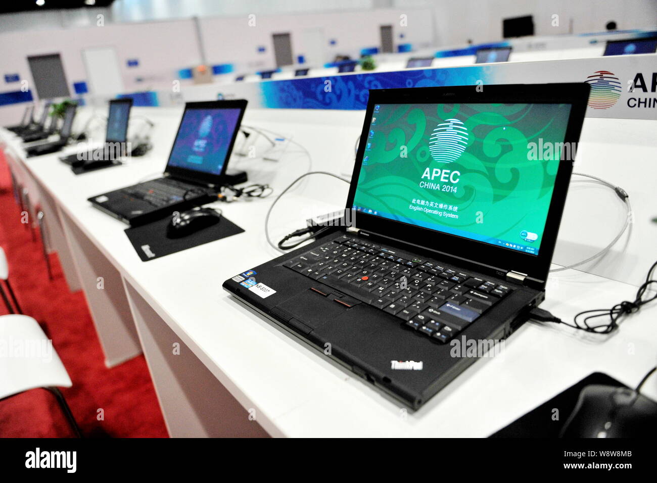 Lenovo ThinkPad laptop computers are lined up at the media center ahead of APEC China 2014 at the China National Convention Center in Beijing, China, Stock Photo
