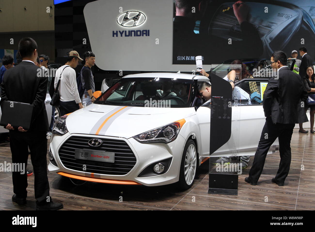 --FILE--Visitors look at or try out a Hyundai Veloster Turbo-GDi during an automobile exhibition in Nanjing city, east Chinas Jiangsu province, 3 Octo Stock Photo